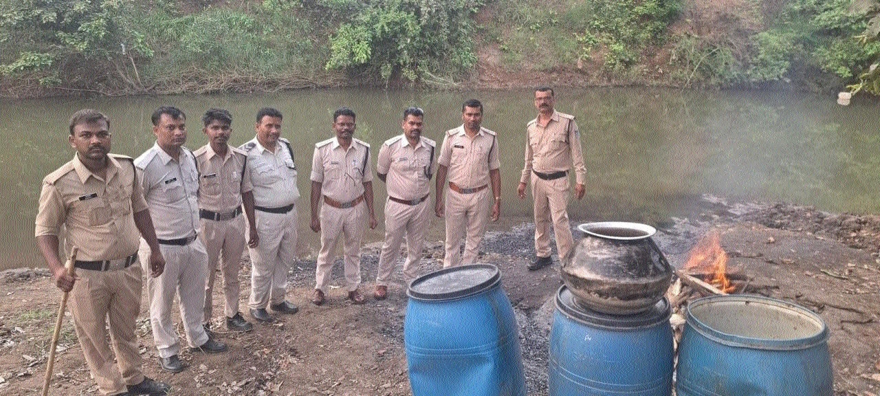 Excise team personnel with the seized stock of liquor and raw 