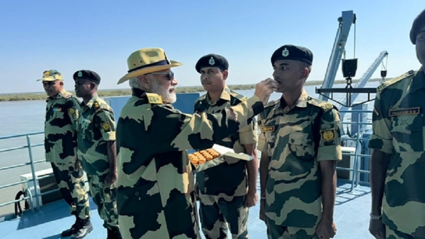 Prime Minister Narendra Modi offers sweets to jawans