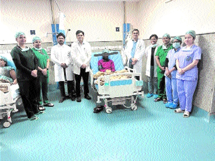 The entire team of doctors and paramedics along with the patient after the successful surgery