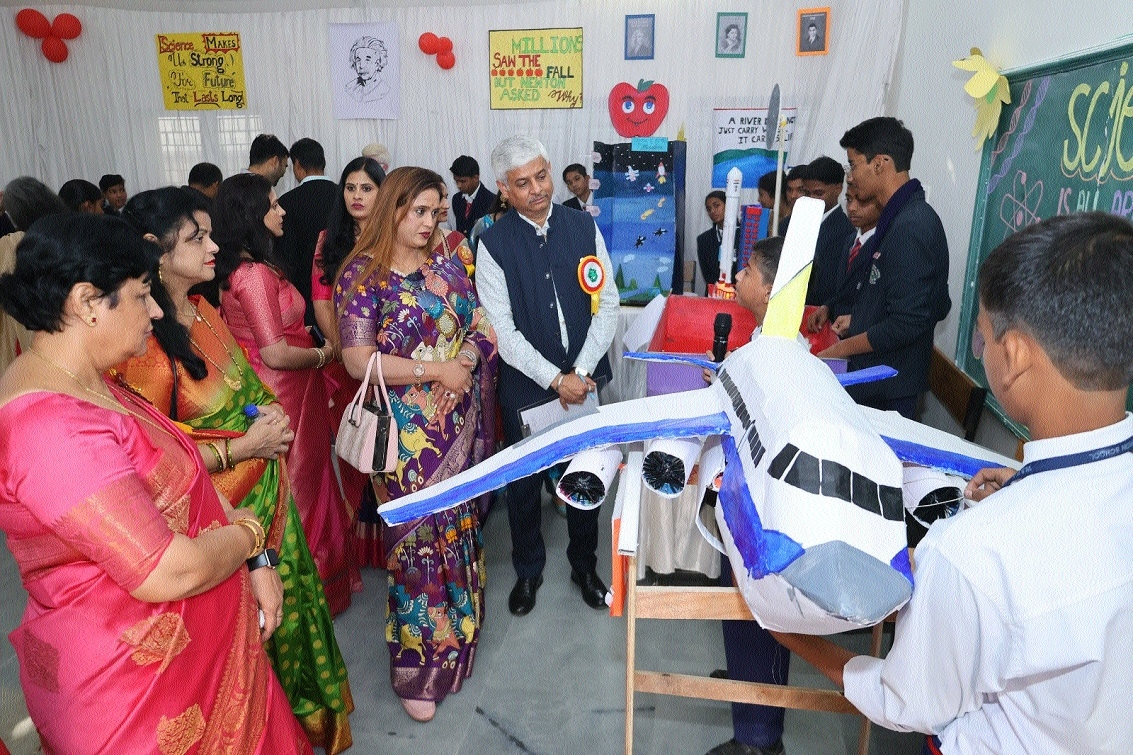 Guests interract with students about science models during the exhibition