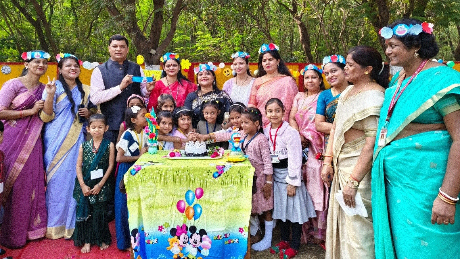 Students and teachers cutting cake as part of the celebration