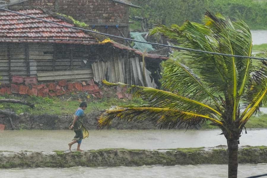 Villagers walk in a flooded area